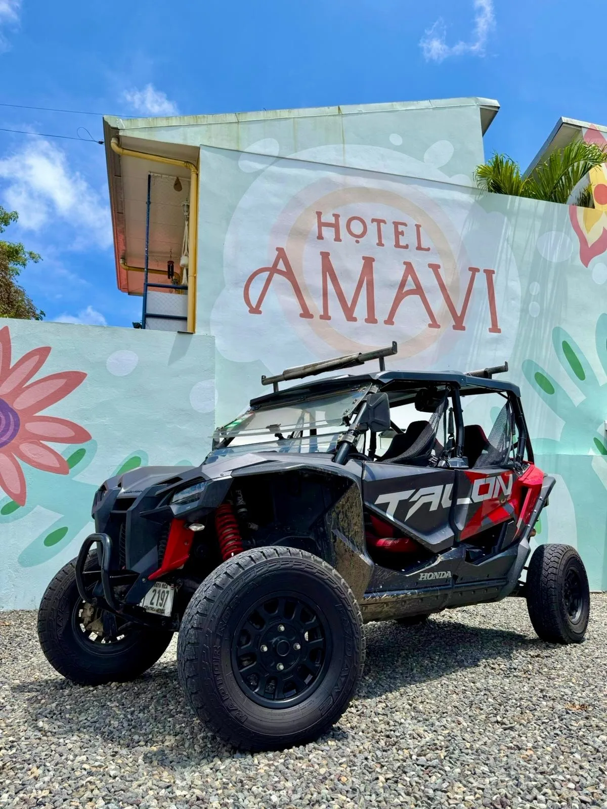 Hotel Amavi mural wall sign with an off-road buggy parked in front