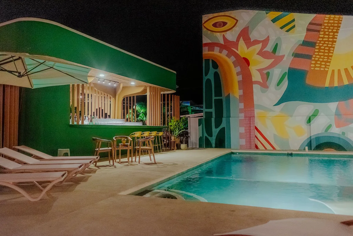 Amavi pool and mural wall lit up at night
