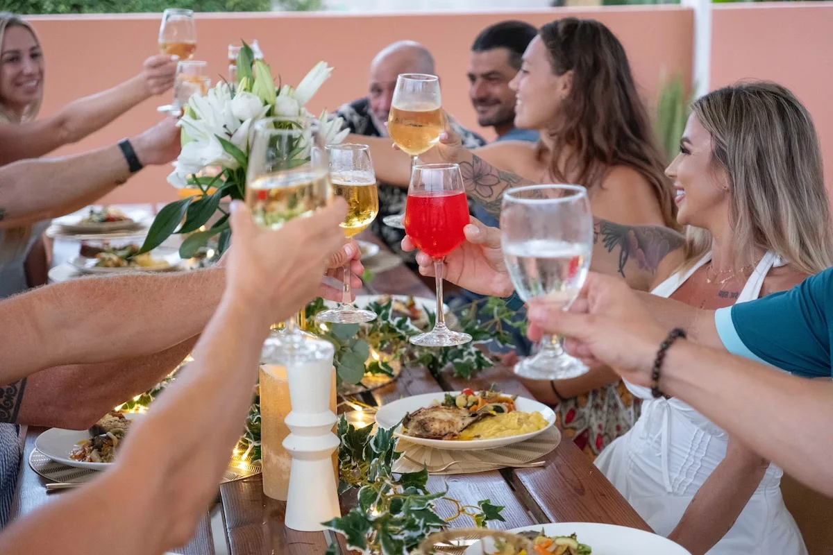 Friends toasting around the long dinner table