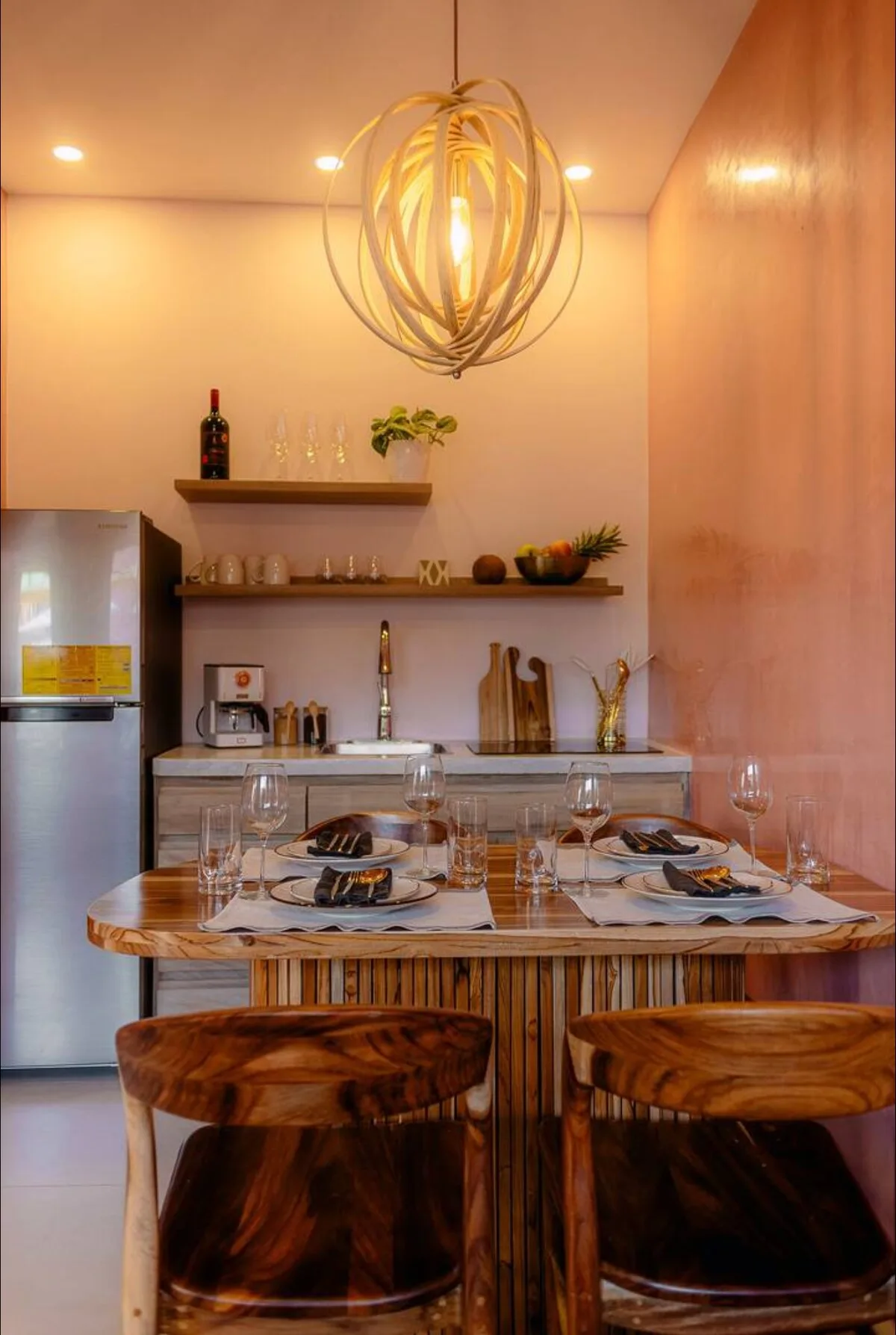 Kitchenette with a pendant light and wooden bar stools