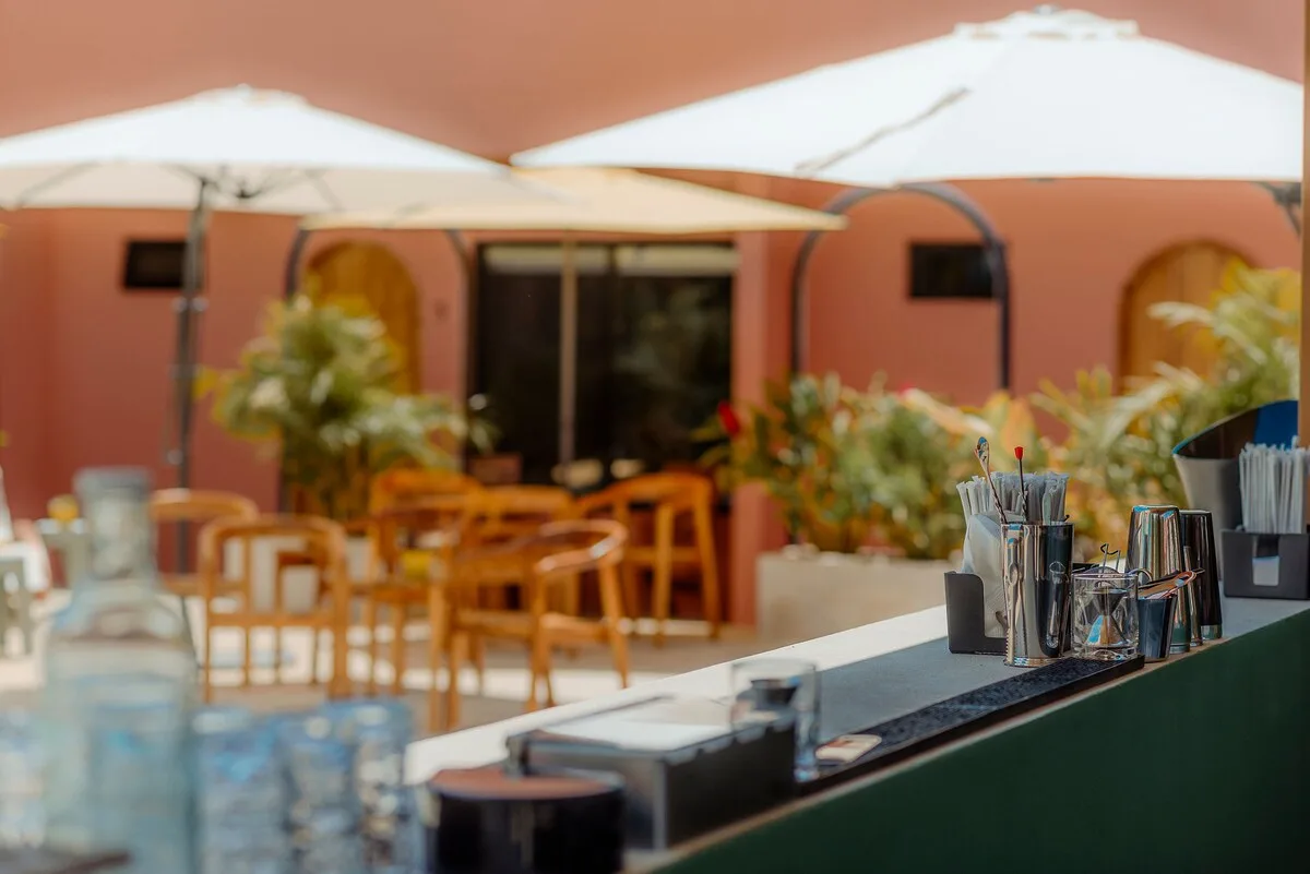 Outdoor bar with umbrellas and pool-side seating