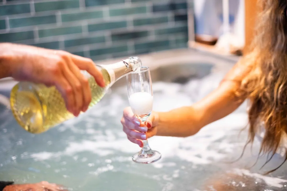 Pouring champagne in the hot tub
