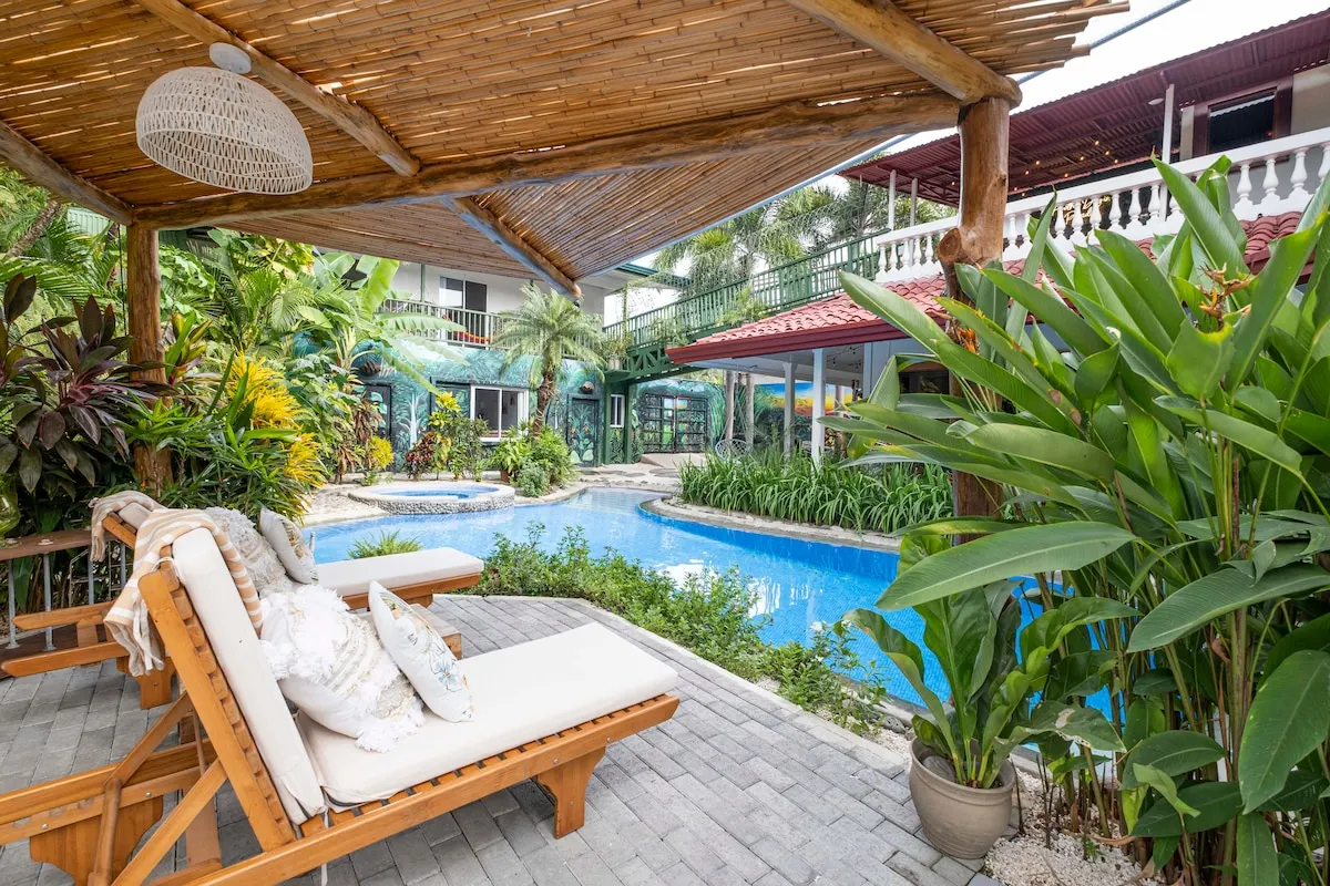 Sun loungers beside the pool in the tropical garden