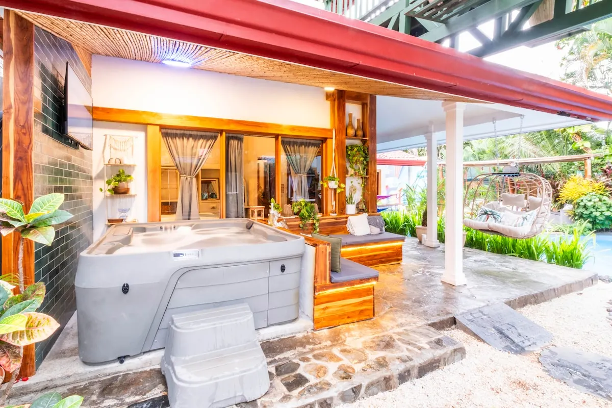 Covered hot tub on the patio of the main villa