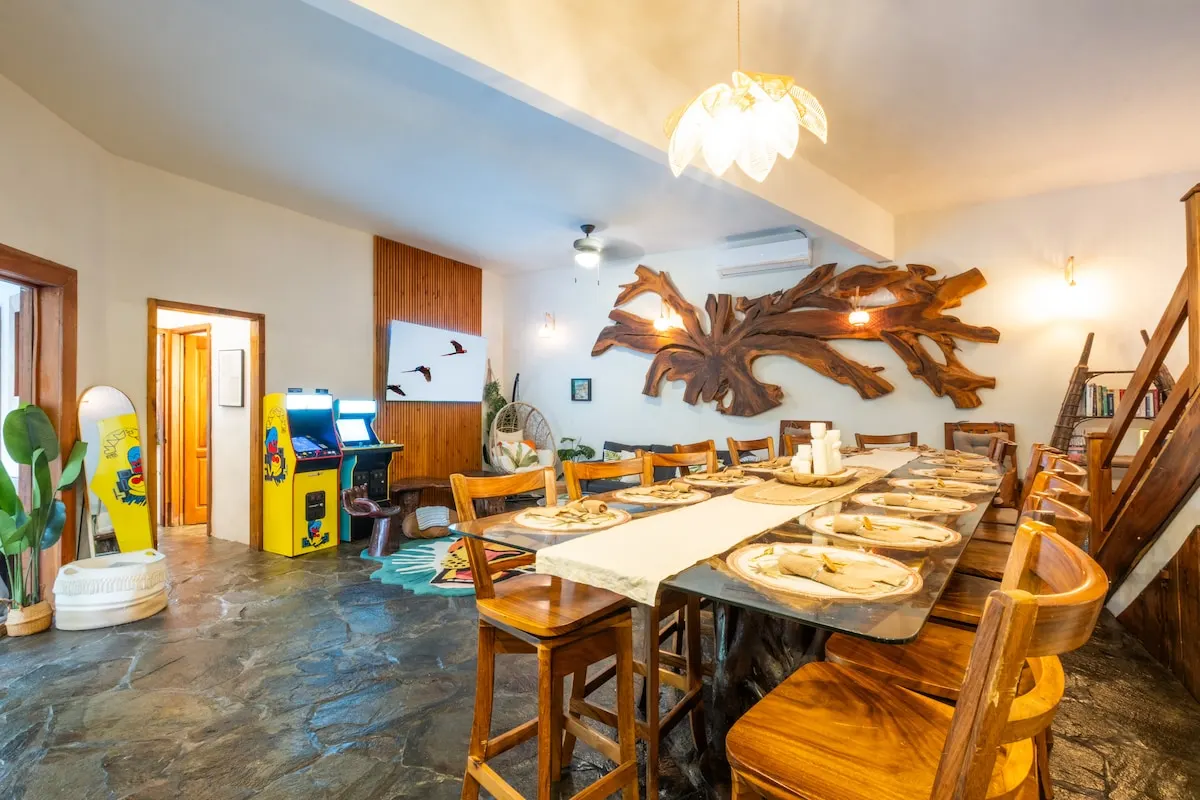 Long dining table with arcade games in the main villa