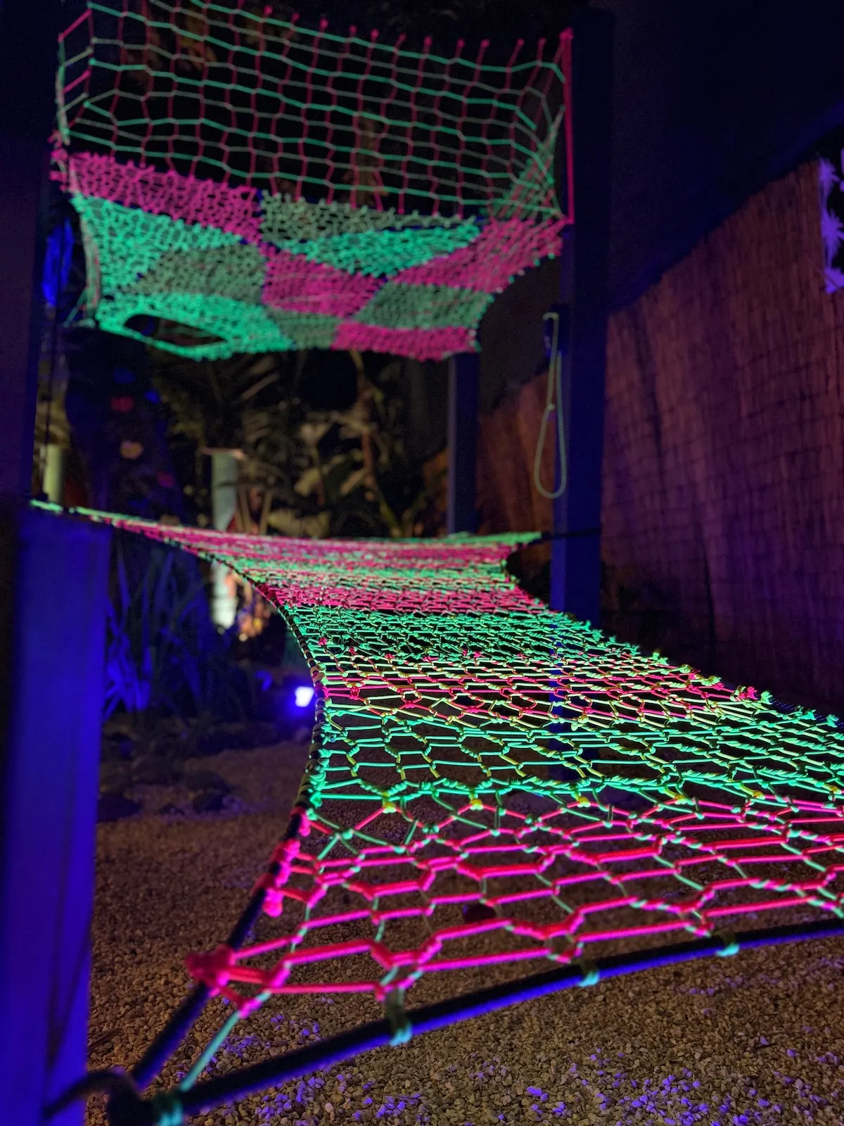 Netted lounge under black light at night