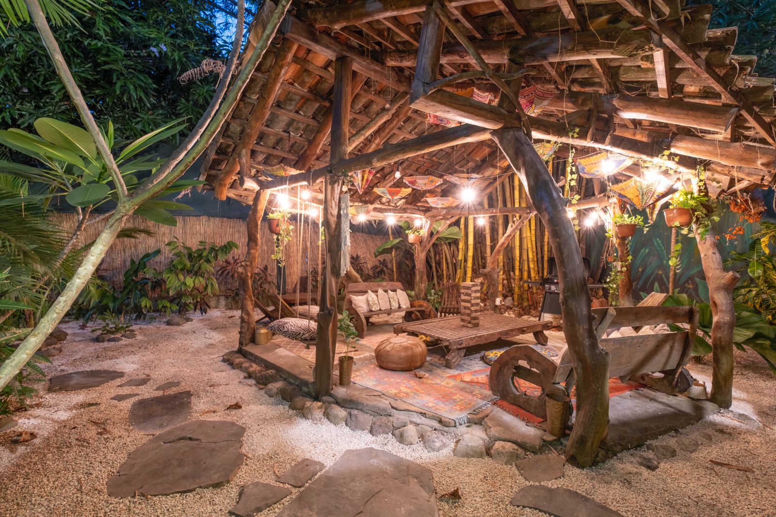Garden gazebo lounge with string lights at night