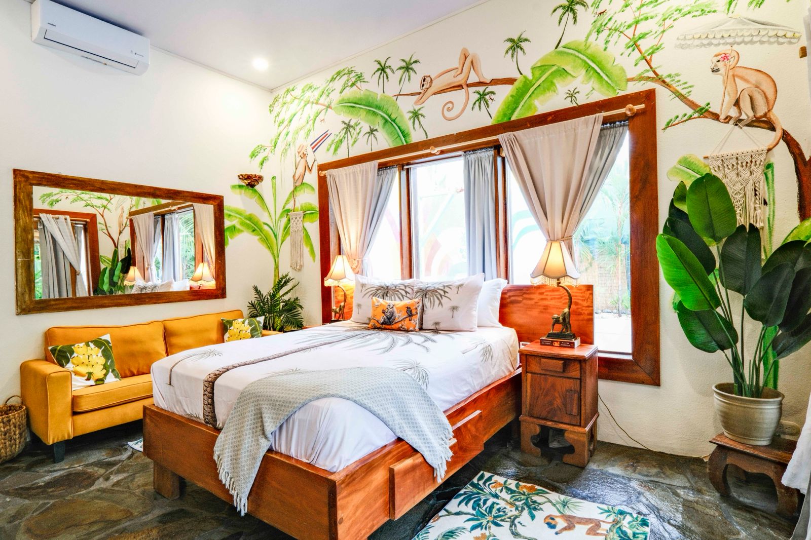 Bedroom with jungle monkey mural and wooden bed
