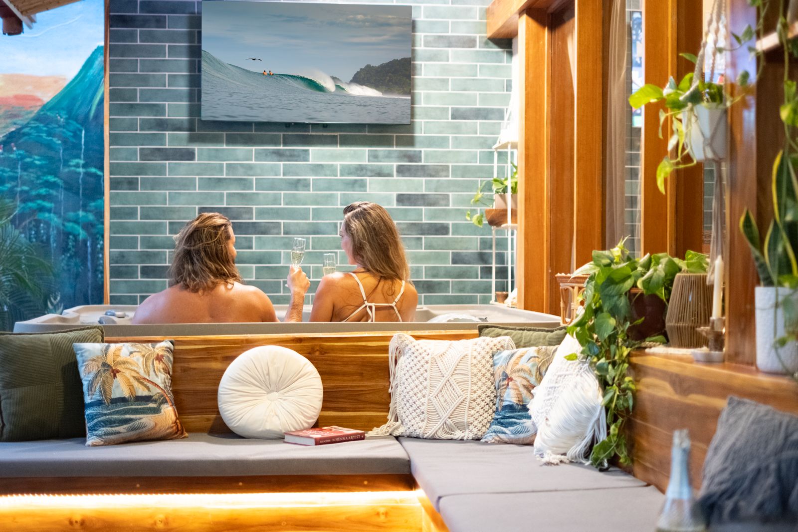 Couple in the hot tub watching a surf video