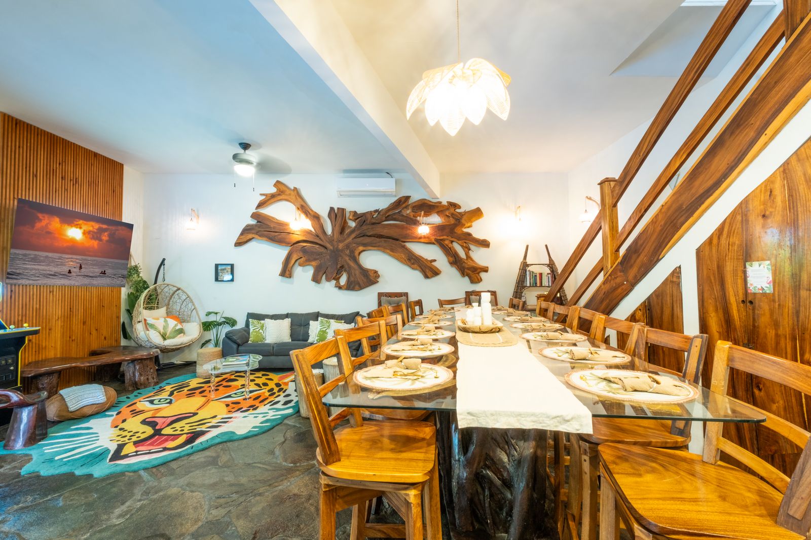Long dining table set for a group beside the living room