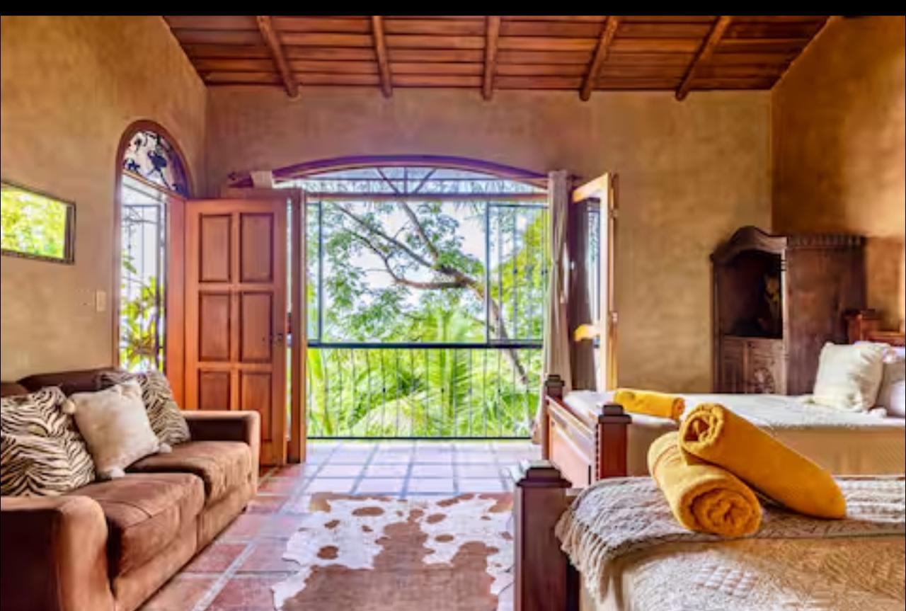 Bedroom with jungle view through open doors