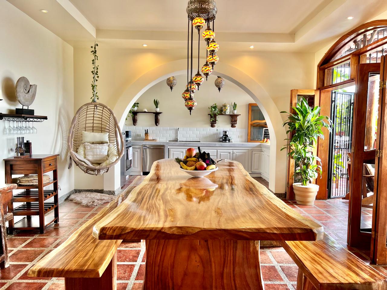 Dining area with handmade table and arched windows