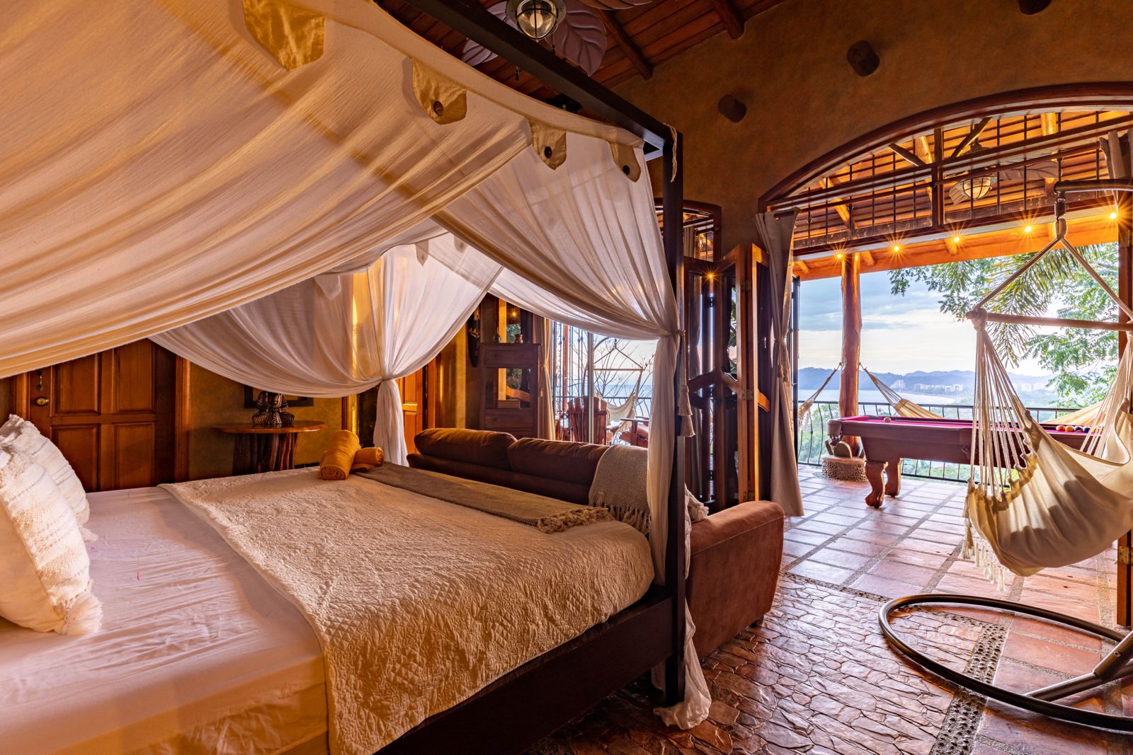 Canopy bed with ocean view and hammock