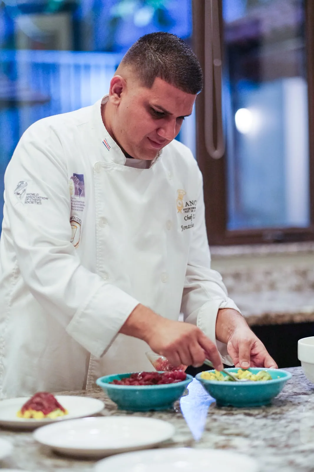 Private chef plating a dish in the kitchen