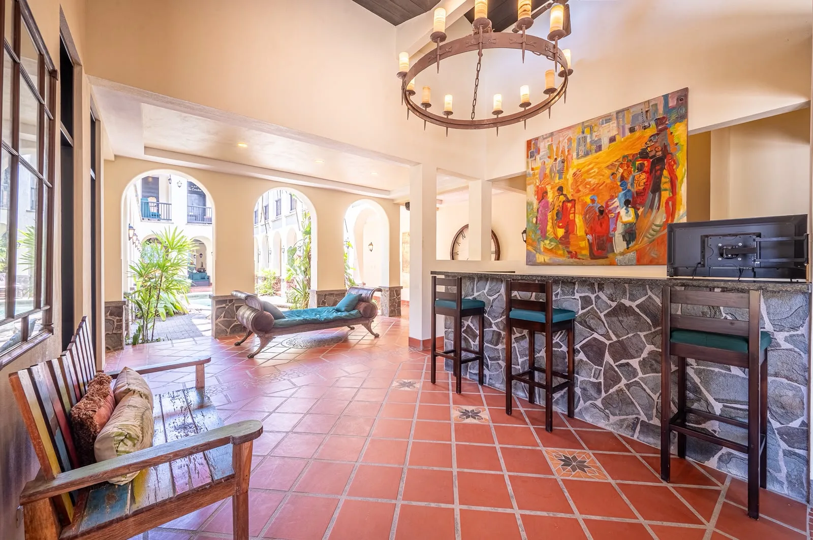 Open lounge and bar with chandelier and tiled floor